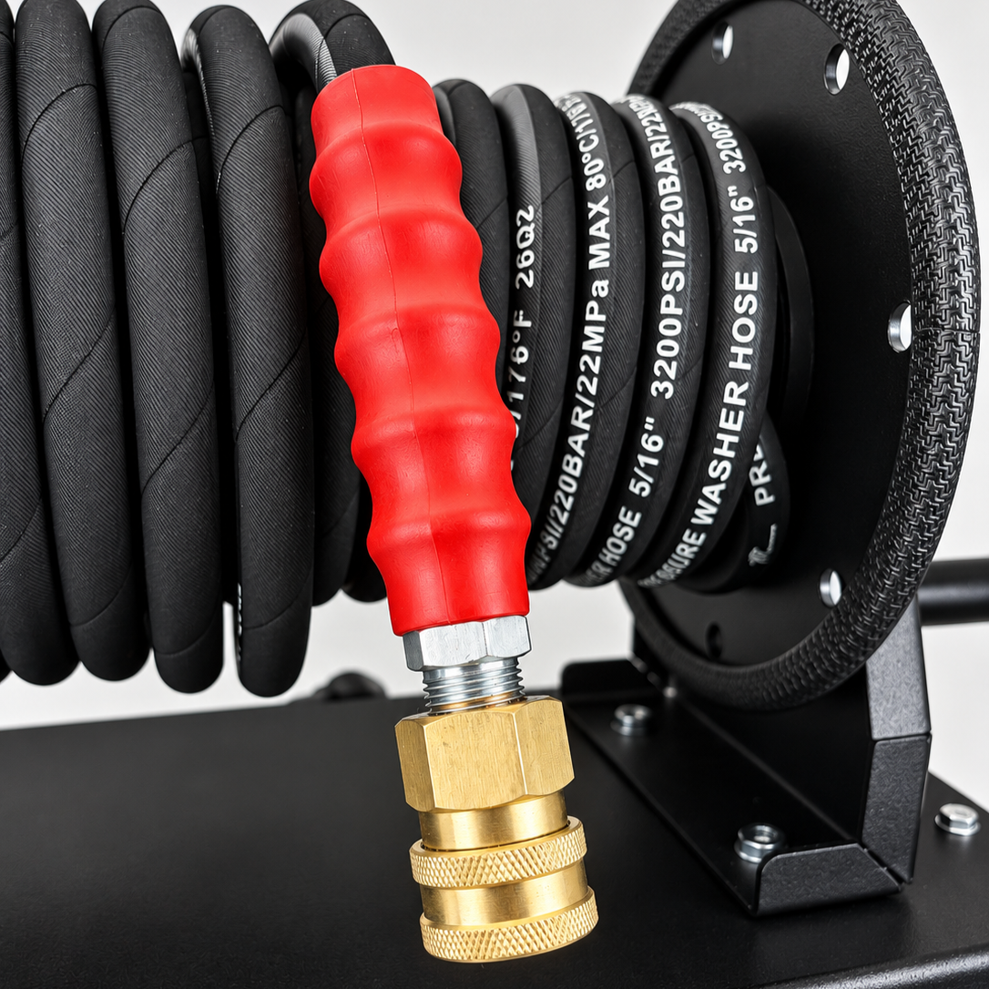 Black high-pressure hose reel for the Paddock™ 1,450 PSI Wall Mountable Pressure Washer, coiled with a red ribbed grip and a brass quick-connect coupling at the end.